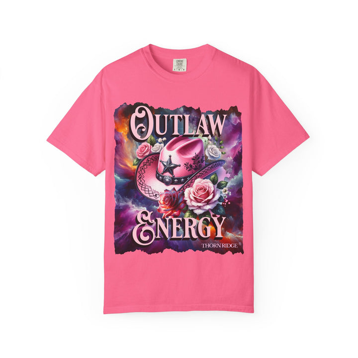 Outlaw Energy graphic tee with a pink cowgirl hat and roses on a celestial background of pinks, blues, and oranges. Labeled Thorn Ridge®