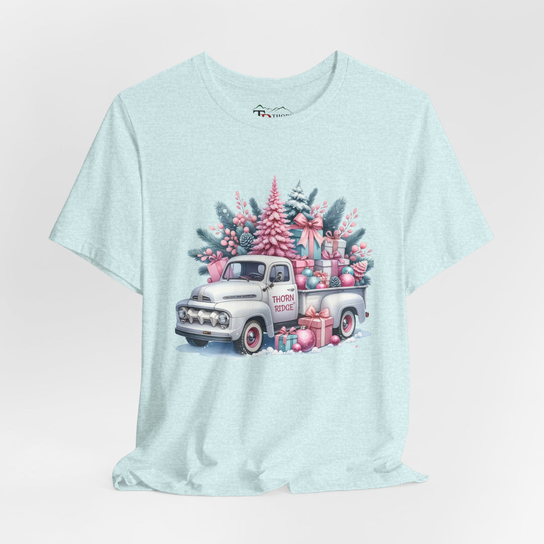 t-shirt with a vintage white truck with the bed filled with pastel colored christmas trees and presents with Thorn ridge on the driver's side door and presents around the door on the ground. 