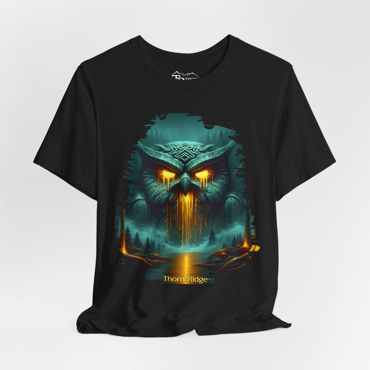 Legend of the Owl King tee by Thorn Ridge with a ancient statue of an owl with glowing lava eyes and mouth in front of a river with fog in the forest. 