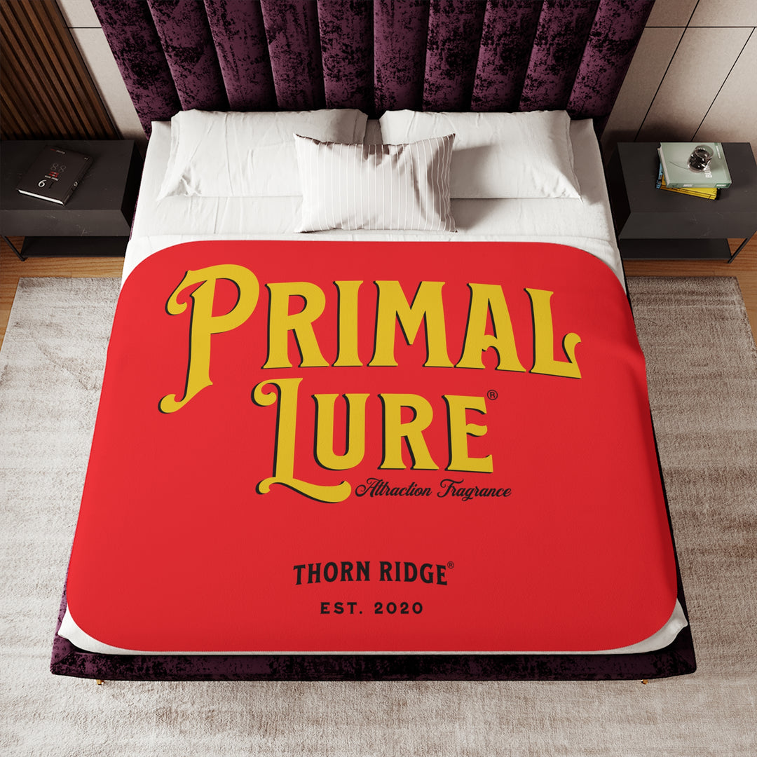 Prinmal Lure Attraction Fragrance by Thorn Ridge® in gold on a red sherpa blanket