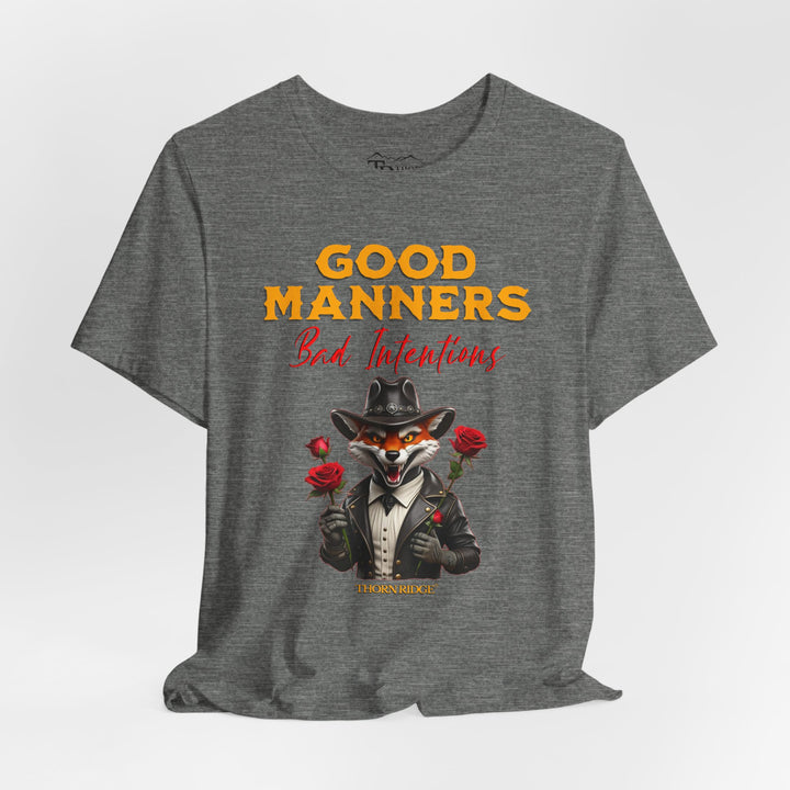 Good manners bad intentions graphic tee with a grinning fox wearing a black cowboy hat and leather jacket with human hands holding roses.  labeled Thorn Ridge®