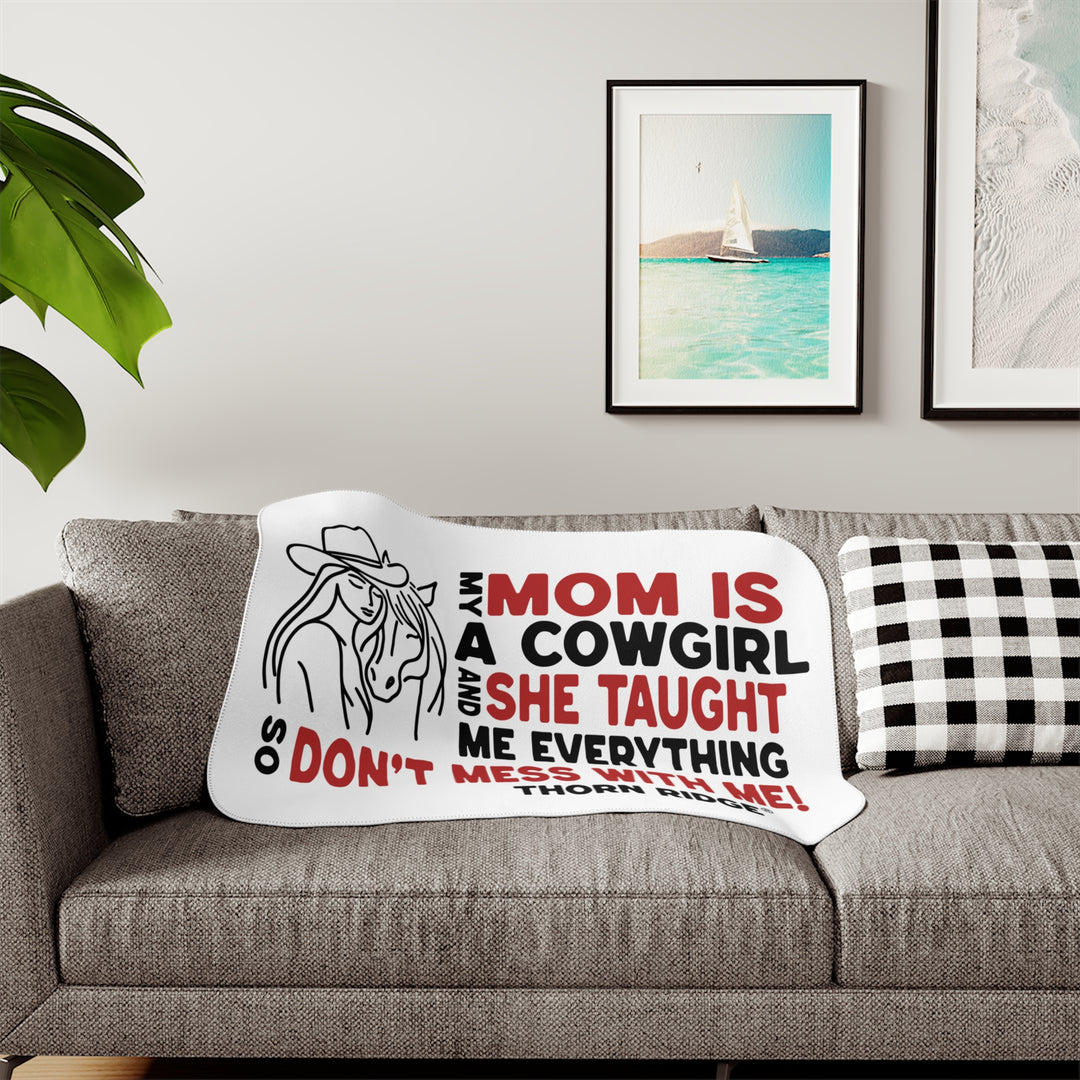 Mom Is A Cowgirl and she taught me everything so don't mess with me slogan graphic with a outline drawing of a woman with a cowboy hat hugging a horse by Thorn Ridge®