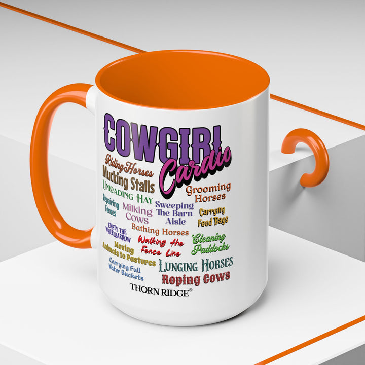 Mug with 'Cowgirl Cardio' text and orange handle on a white background