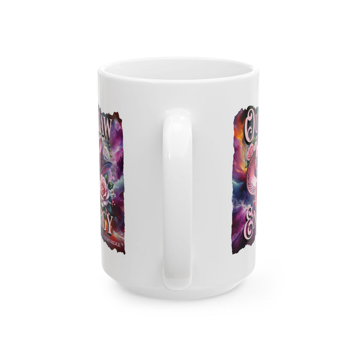 White mug with a colorful design featuring a pink cowboy hat and flowers, labeled 'Outlaw Energy' by Thorn Ridge®