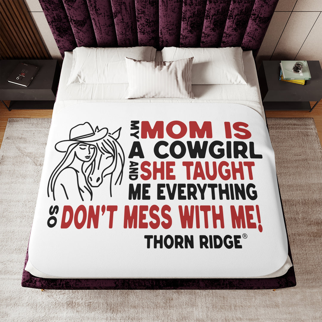 Mom Is A Cowgirl and she taught me everything so don't mess with me slogan graphic with a outline drawing of a woman with a cowboy hat hugging a horse by Thorn Ridge®