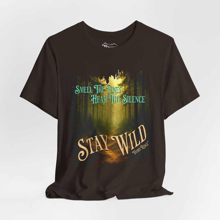 Smell The Pines Hear the Silence Stay Wild graphic tee with the image of a forest path and tall pines labeled Thorn Ridge®