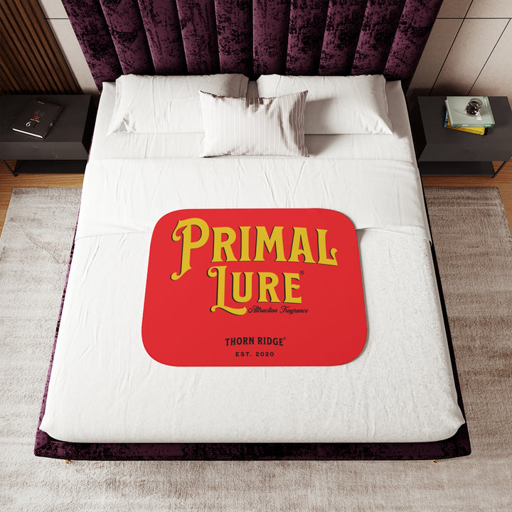 Prinmal Lure Attraction Fragrance by Thorn Ridge® in gold on a red sherpa blanket