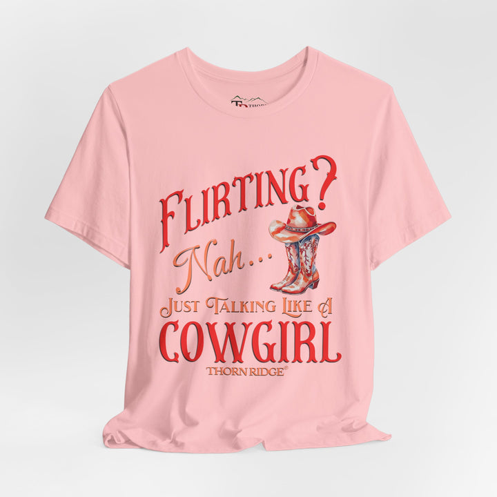 "Flirting? Nah... just talking like a cowgirl" graphic tee with women's cowgirl boots with a cowgirl hat sitting on top. Labeled Thorn Ridge®
