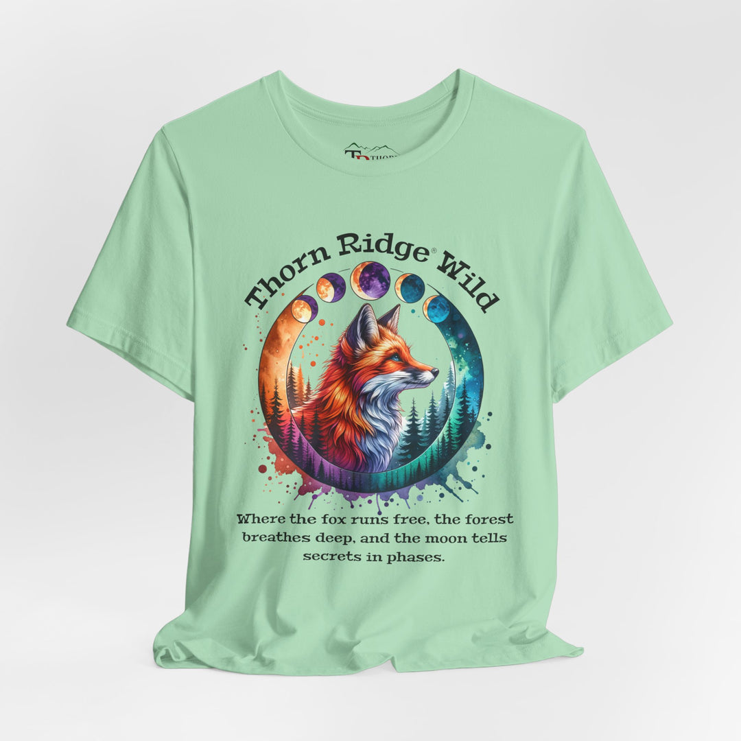 Thorn Ridge Wild Graphic Tee featuring a fox, forest, and moon phases. 