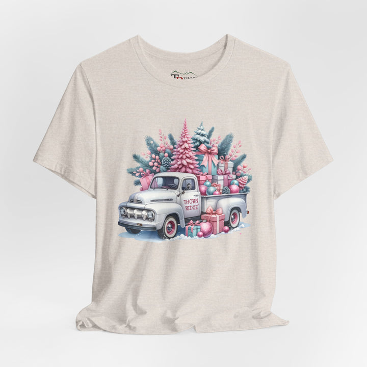 t-shirt with a vintage white truck with the bed filled with pastel colored christmas trees and presents with Thorn ridge on the driver's side door and presents around the door on the ground. 