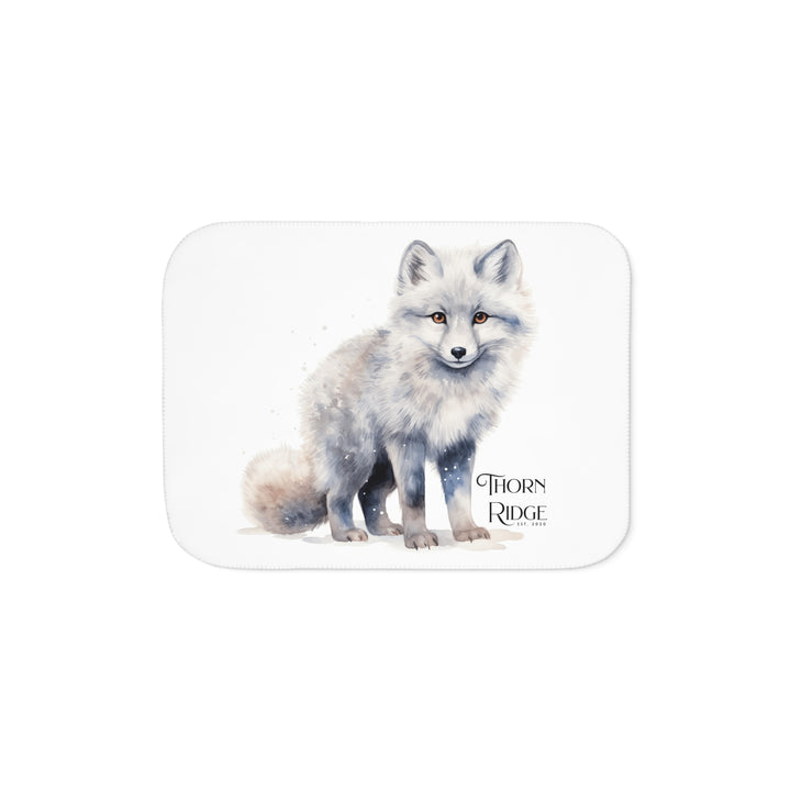 White Arctic fox illustration on a white Sherpa Blanket with 'Thorn Ridge' branding.