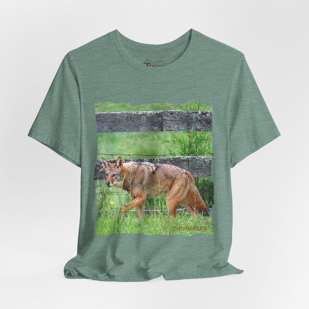 t-shirt with a photo of a red coyote against a weathered board fence and green grass labeled Thorn Ridge®