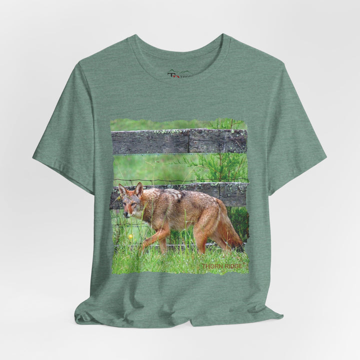 t-shirt with a photo of a red coyote against a weathered board fence and green grass labeled Thorn Ridge®