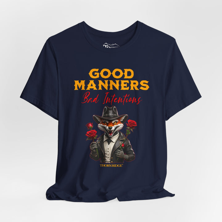 Good manners bad intentions graphic tee with a grinning fox wearing a black cowboy hat and leather jacket with human hands holding roses.  labeled Thorn Ridge®