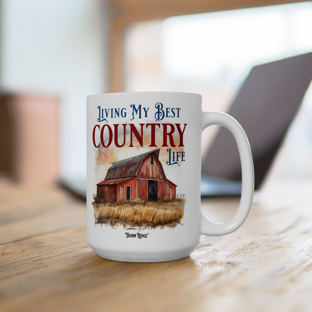 Mug with a red barn illustration and 'Living My Best Country Life' text on a white background with Thorn Ridge branding.