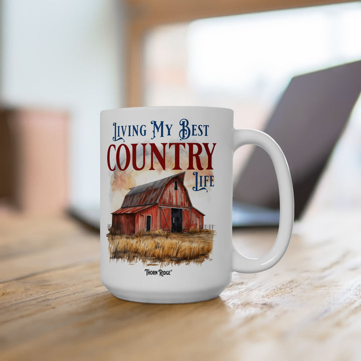 Mug with a red barn illustration and 'Living My Best Country Life' text on a white background with Thorn Ridge branding.