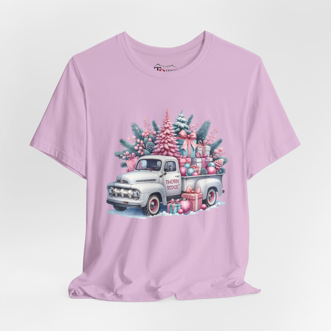 t-shirt with a vintage white truck with the bed filled with pastel colored christmas trees and presents with Thorn ridge on the driver's side door and presents around the door on the ground. 