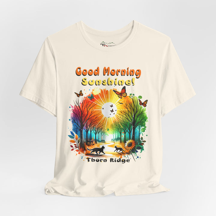 good morning sunshine graphic tee by Thorn Ridge featuring the sun shining through the trees and two cats walking across the path in a park.