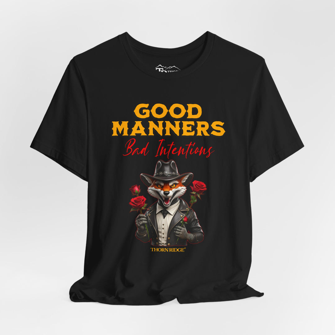 Good manners bad intentions graphic tee with a grinning fox wearing a black cowboy hat and leather jacket with human hands holding roses.  labeled Thorn Ridge®