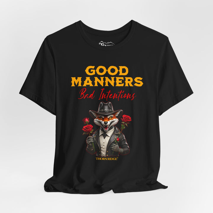 Good manners bad intentions graphic tee with a grinning fox wearing a black cowboy hat and leather jacket with human hands holding roses.  labeled Thorn Ridge®