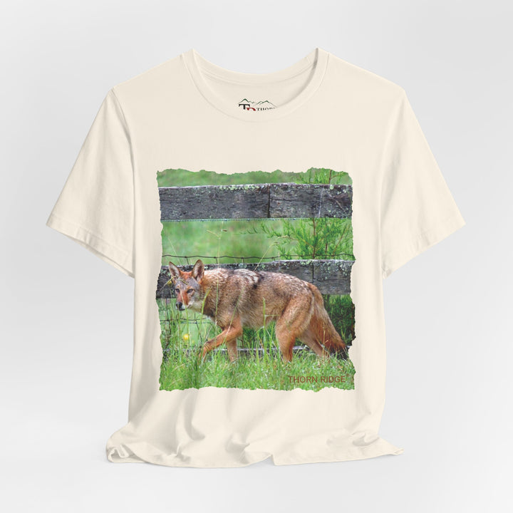 t-shirt with a photo of a red coyote against a weathered board fence and green grass labeled Thorn Ridge®