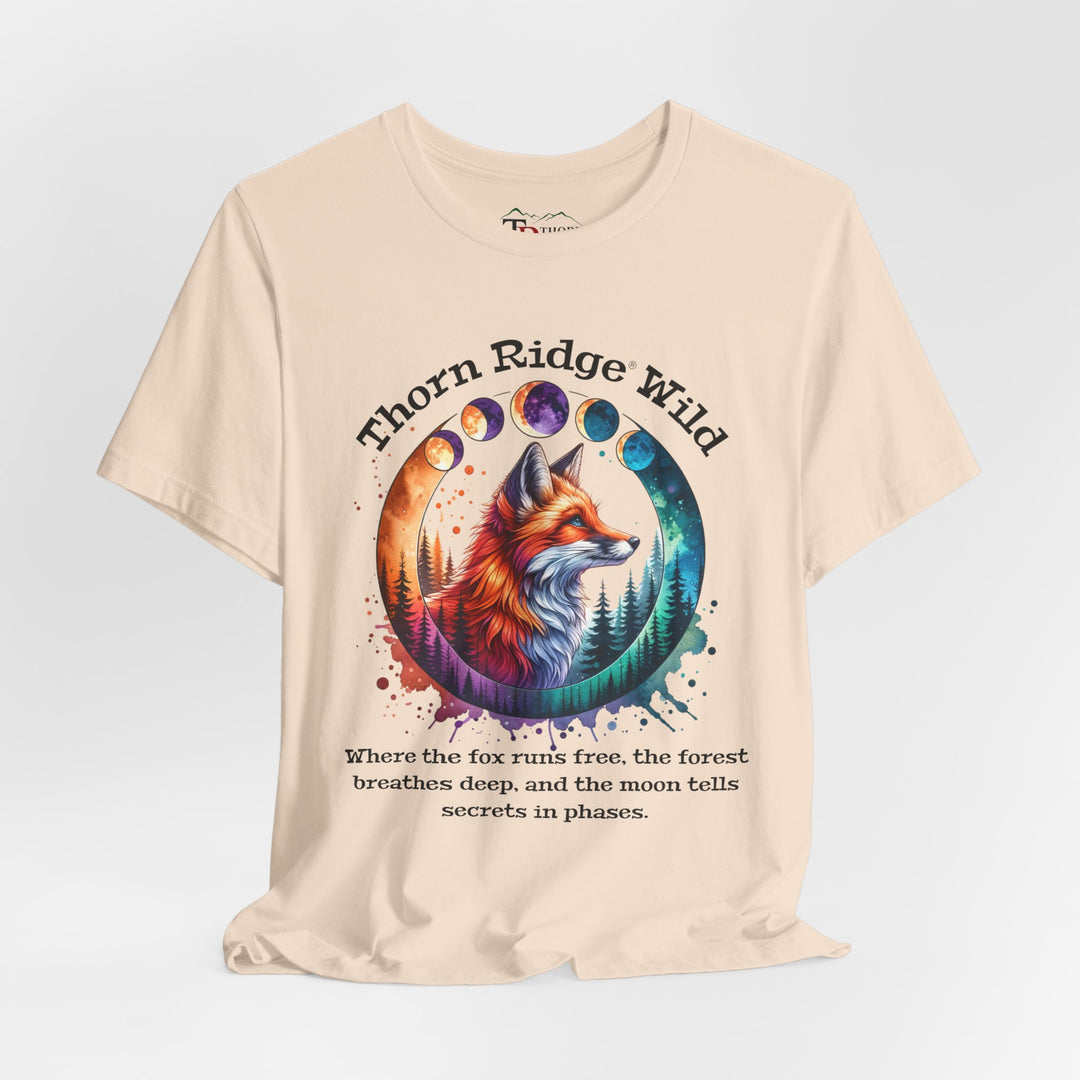 Thorn Ridge Wild Graphic Tee featuring a fox, forest, and moon phases. 