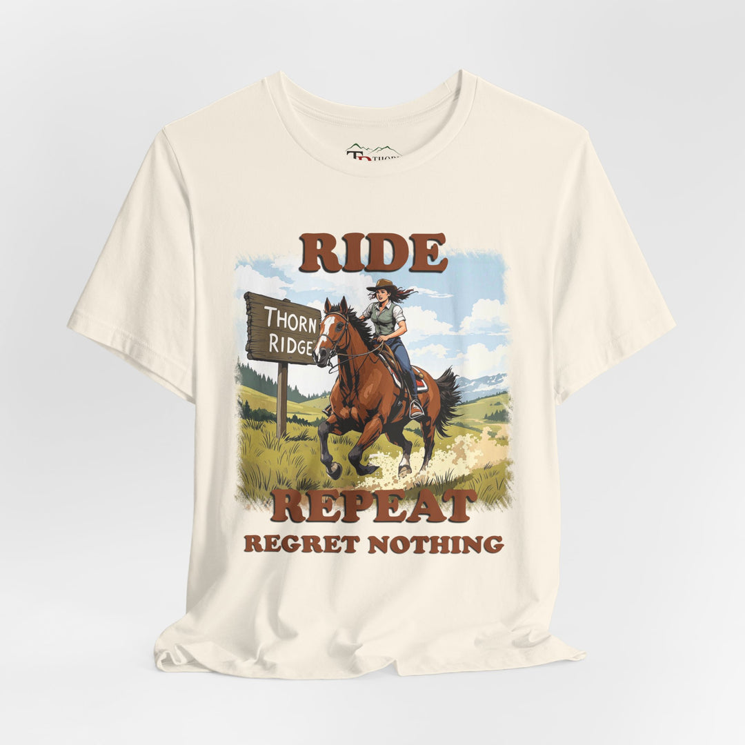Ride Repeat Regret Nothing tee with a woman riding a galloping horse across the feild with the mountains in the background and a sign labeled Thorn Ridge®