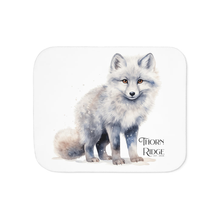 White Arctic fox illustration on a white Sherpa Blanket with 'Thorn Ridge' branding.