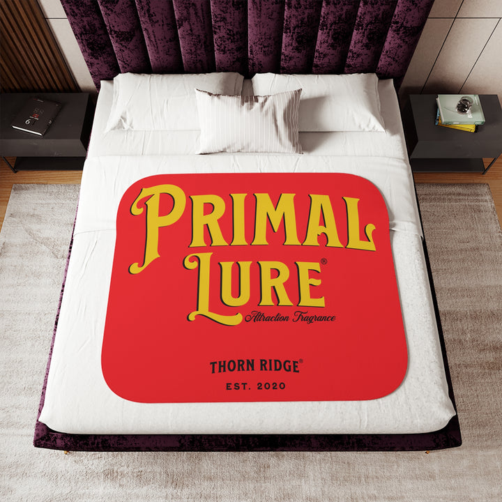Prinmal Lure Attraction Fragrance by Thorn Ridge® in gold on a red sherpa blanket