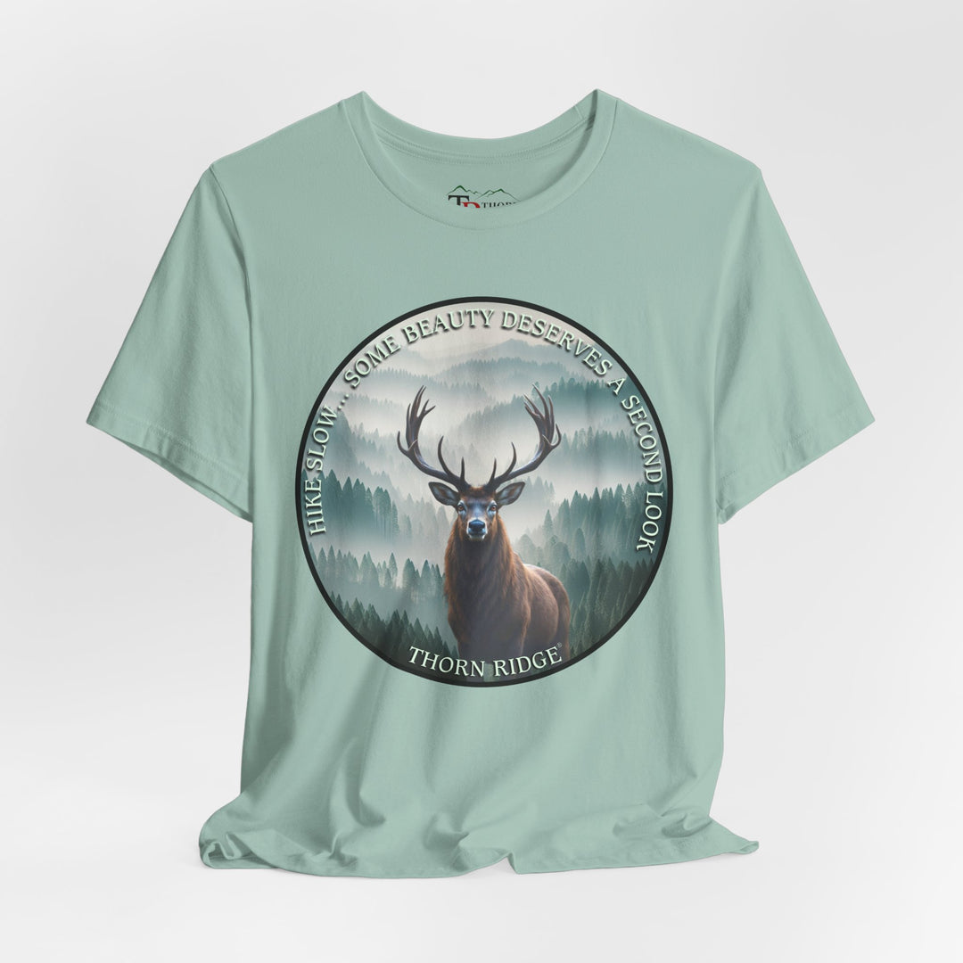 Hike Slow Some Beauty Deserves a Second Look tee with deer and mountains within a circular graphic by Thorn Ridge®