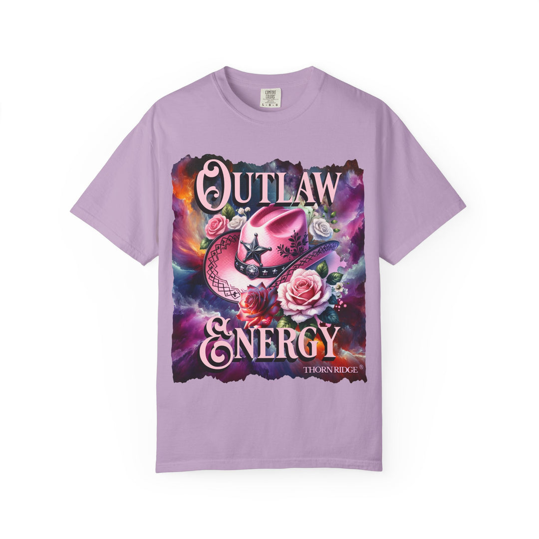 Outlaw Energy graphic tee with a pink cowgirl hat and roses on a celestial background of pinks, blues, and oranges. Labeled Thorn Ridge®