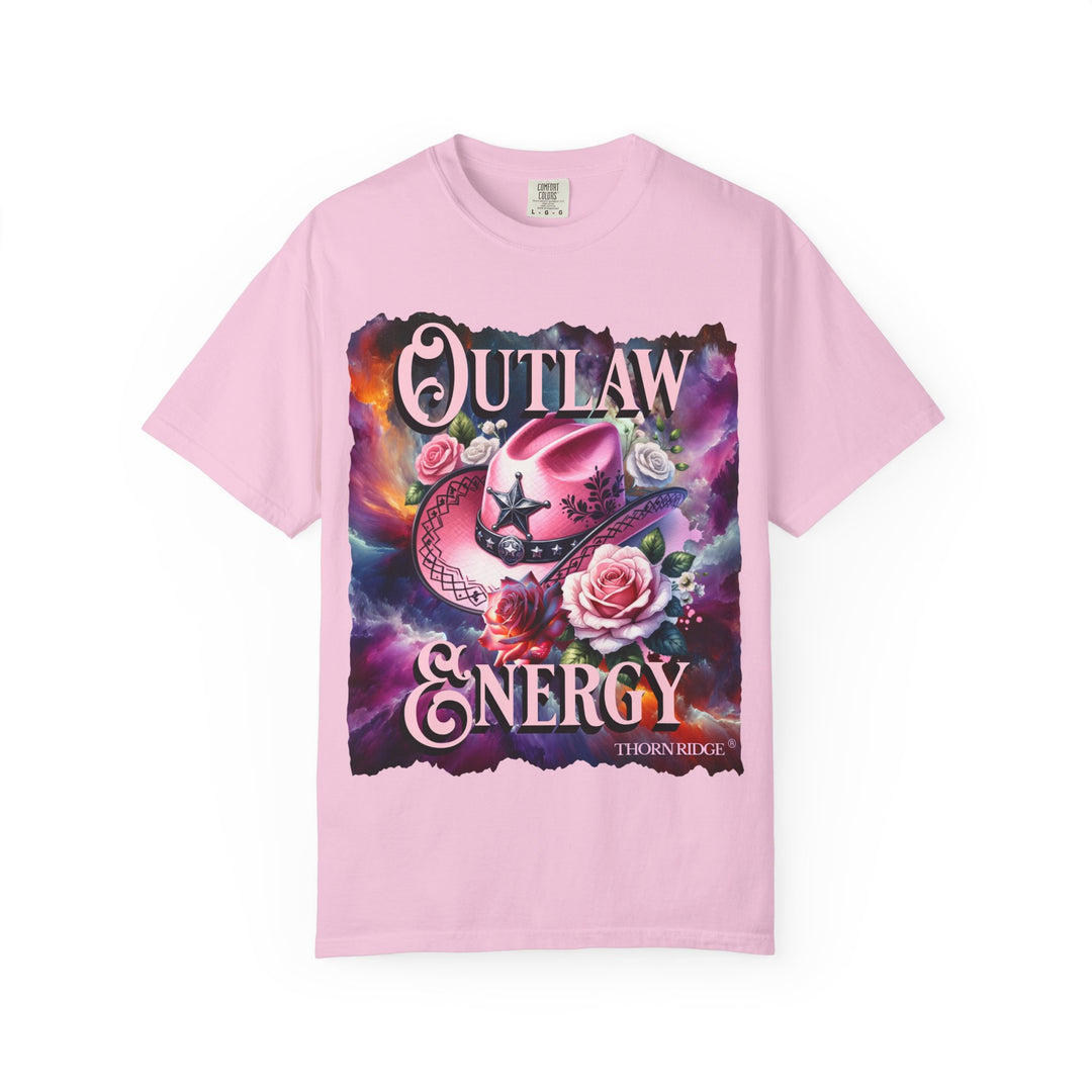 Outlaw Energy graphic tee with a pink cowgirl hat and roses on a celestial background of pinks, blues, and oranges. Labeled Thorn Ridge®