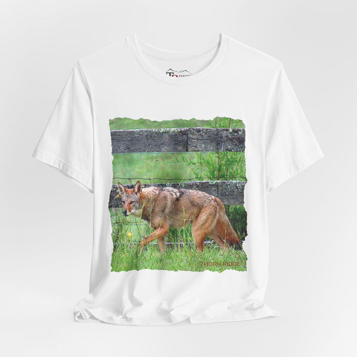 t-shirt with a photo of a red coyote against a weathered board fence and green grass labeled Thorn Ridge®