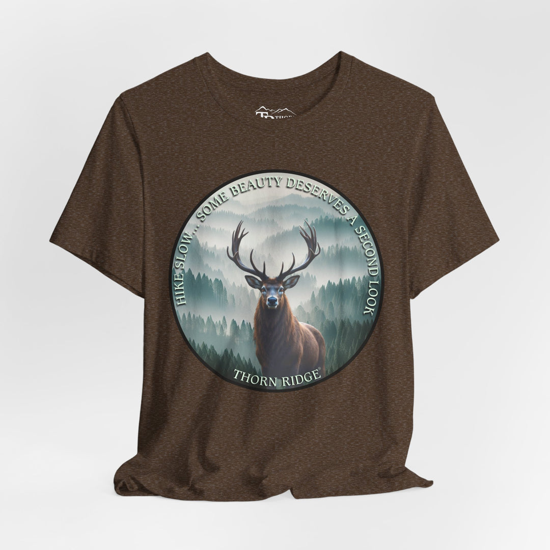Hike Slow Some Beauty Deserves a Second Look tee with deer and mountains within a circular graphic by Thorn Ridge®