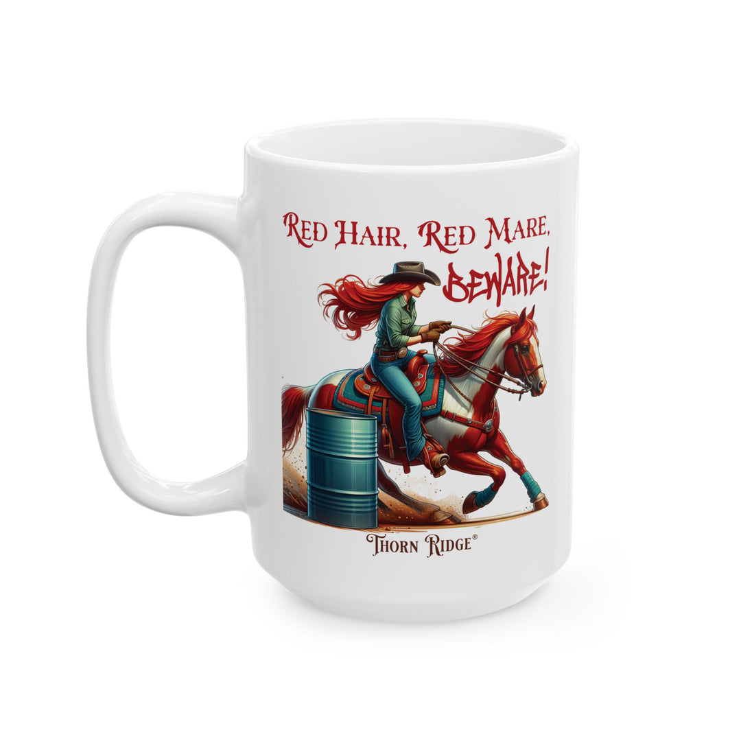 White mug with a graphic of a red haired woman on a chestnut mare and text 'Red Hair, Red Mare, Beware!' racing around a barrel by Thorn Ridge®