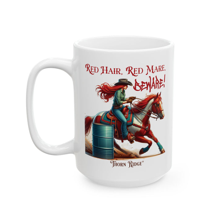 White mug with a graphic of a red haired woman on a chestnut mare and text 'Red Hair, Red Mare, Beware!' racing around a barrel by Thorn Ridge®