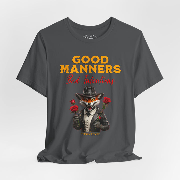 Good manners bad intentions graphic tee with a grinning fox wearing a black cowboy hat and leather jacket with human hands holding roses.  labeled Thorn Ridge®