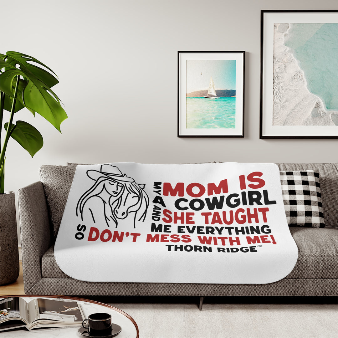 Mom Is A Cowgirl and she taught me everything so don't mess with me slogan graphic with a outline drawing of a woman with a cowboy hat hugging a horse by Thorn Ridge®