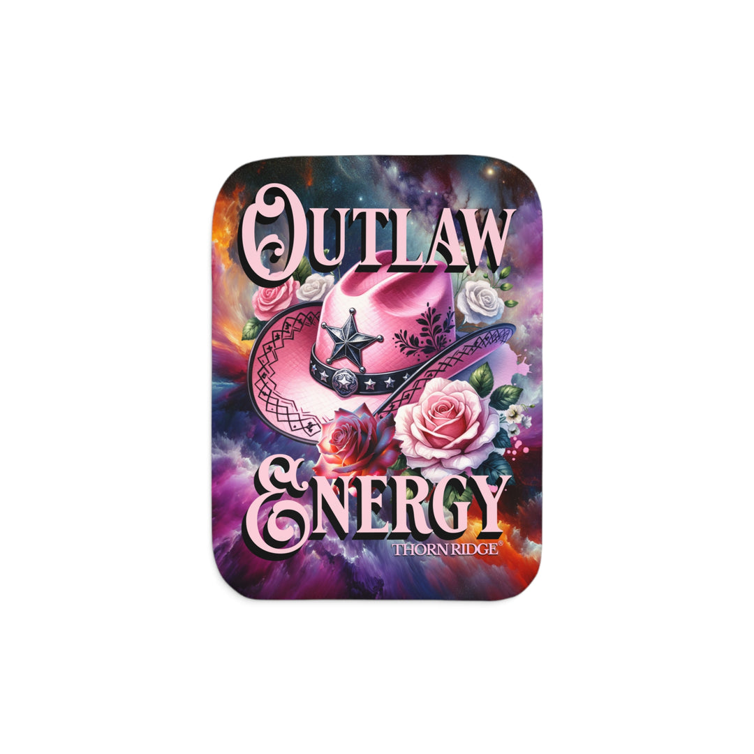 Colorful sherpa blanket with cowboy hat, roses, and 'Outlaw Energy' text on a cosmic background with Thorn Ridge branding.
