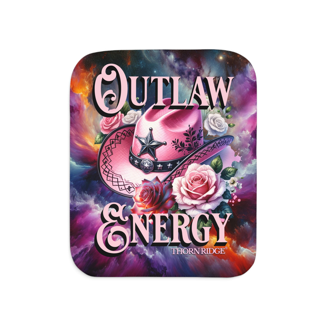 Colorful sherpa blanket with cowboy hat, roses, and 'Outlaw Energy' text on a cosmic background with Thorn Ridge branding.