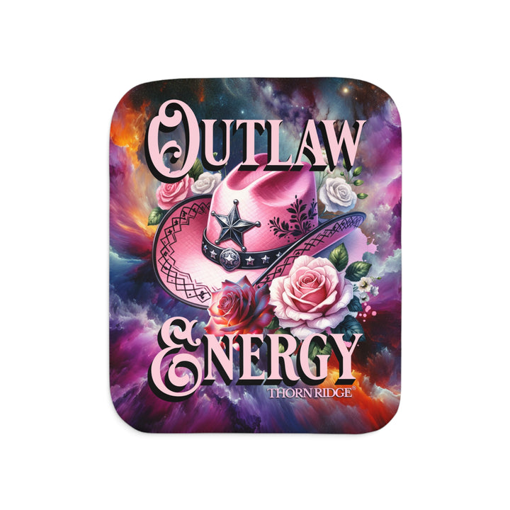 Colorful sherpa blanket with cowboy hat, roses, and 'Outlaw Energy' text on a cosmic background with Thorn Ridge branding.