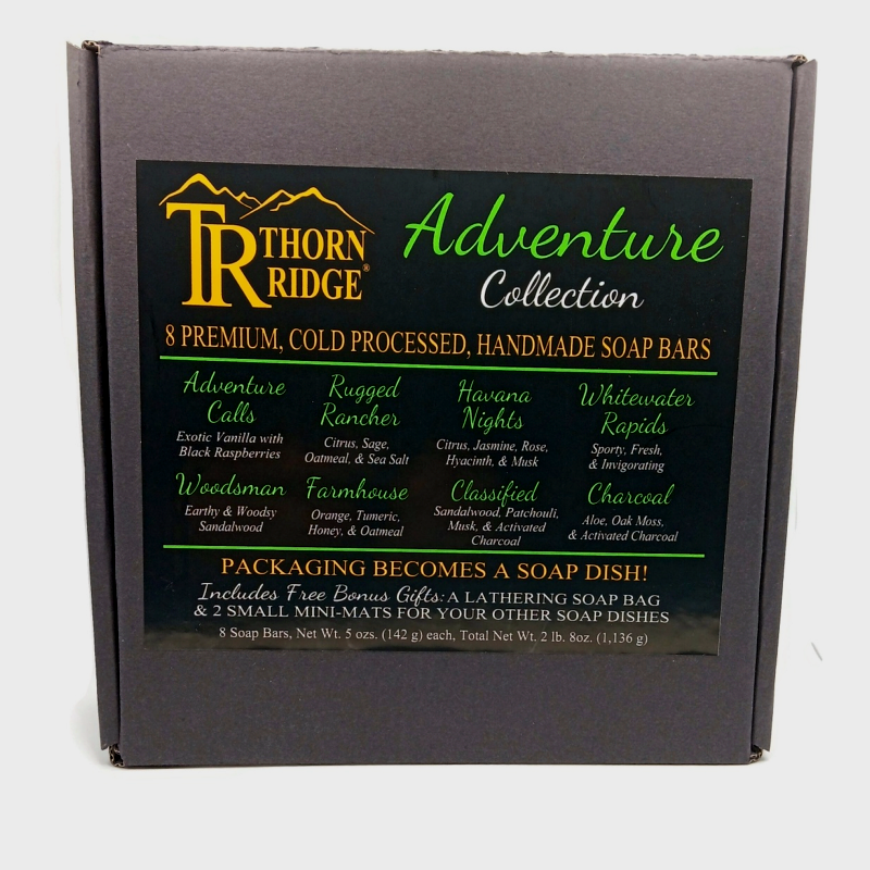 Packaging of Thorn Ridge soap gift set labeled "Adventure Collection," described as containing 8 individually packaged soaps, lathering soap bag, 2 extra mini mats, premium cold processed, handmade, 5 oz each (2 lb 8 oz), Made in USA.