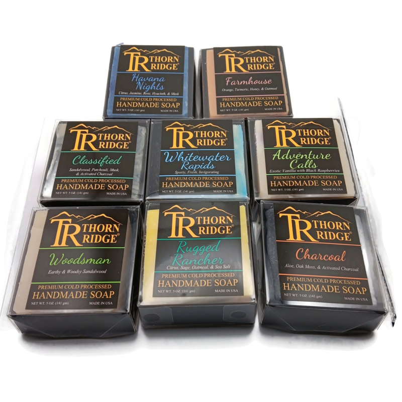 Packaging of Thorn Ridge soap gift set labeled "Adventure Collection," described as containing 8 individually packaged soaps, lathering soap bag, 2 extra mini mats, premium cold processed, handmade, 5 oz each (2 lb 8 oz), Made in USA.