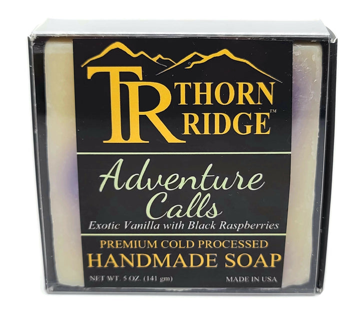 Packaging of Thorn Ridge soap labeled "Adventure Calls," described as exotic vanilla with black raspberries, premium cold processed, handmade, 5 oz. Made in USA.