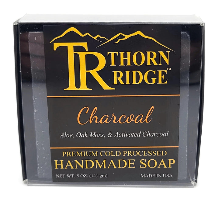 Packaging of Thorn Ridge soap labeled "Charcoal," described as aloe, oak moss, activated charcoal,  premium cold processed, handmade, 5 oz. Made in USA.