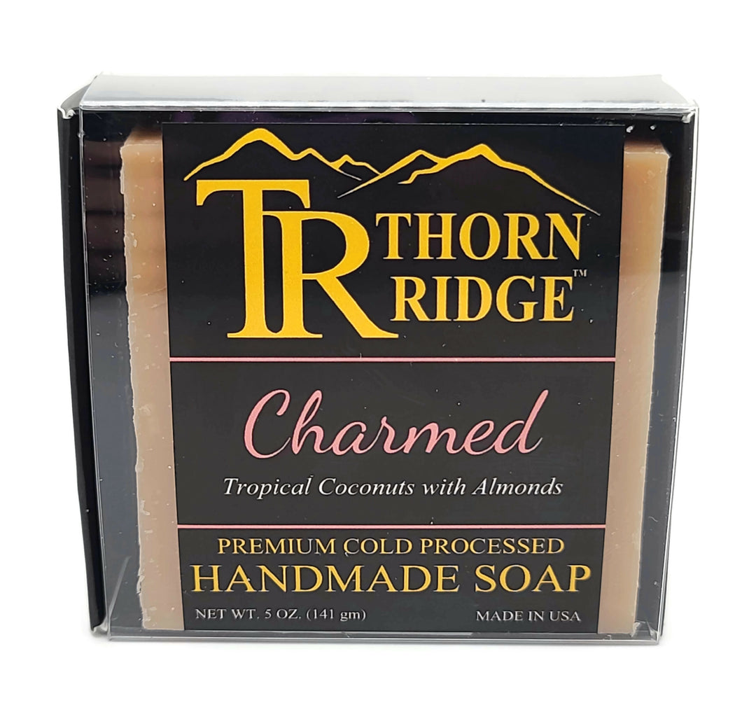 Packaging of Thorn Ridge soap labeled "Charmed," described as tropical coconuts with almonds scent, premium cold processed, handmade, 5 oz. Made in USA.