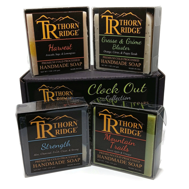 Packaging of Thorn Ridge soap gift set labeled "Clock Out Collection," described as containing 4 individually packaged soaps, lathering soap bag, extra mini mat, premium cold processed, handmade, 5 oz each (1 lb 4 oz), Made in USA.