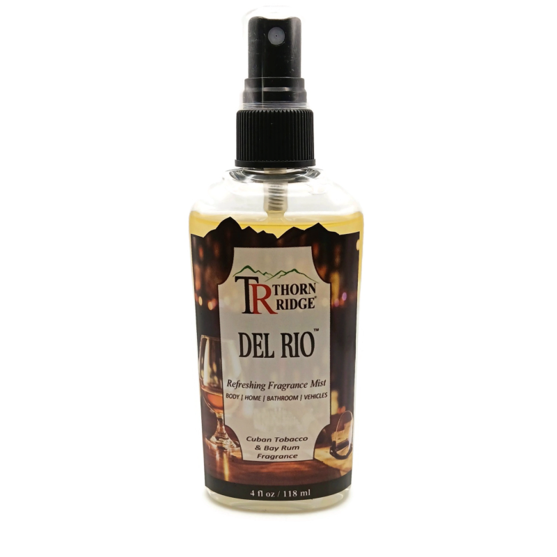 A bottle of Thorn Ridge fragrance mist labeled "Thorn Ridge Del Rio," described as tobacco and bay rum scent for body, home, bathroom, and vehicles. 4 fl oz.