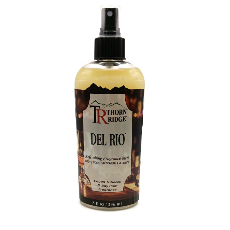 A bottle of Thorn Ridge fragrance mist labeled "Thorn Ridge Del Rio," described as tobacco and bay rum scent for body, home, bathroom, and vehicles. 8 fl oz.