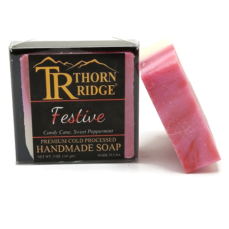 Packaging of Thorn Ridge soap labeled "Festive," described as candy cane, sweet peppermint, premium cold processed, handmade, 5 oz. Made in USA.